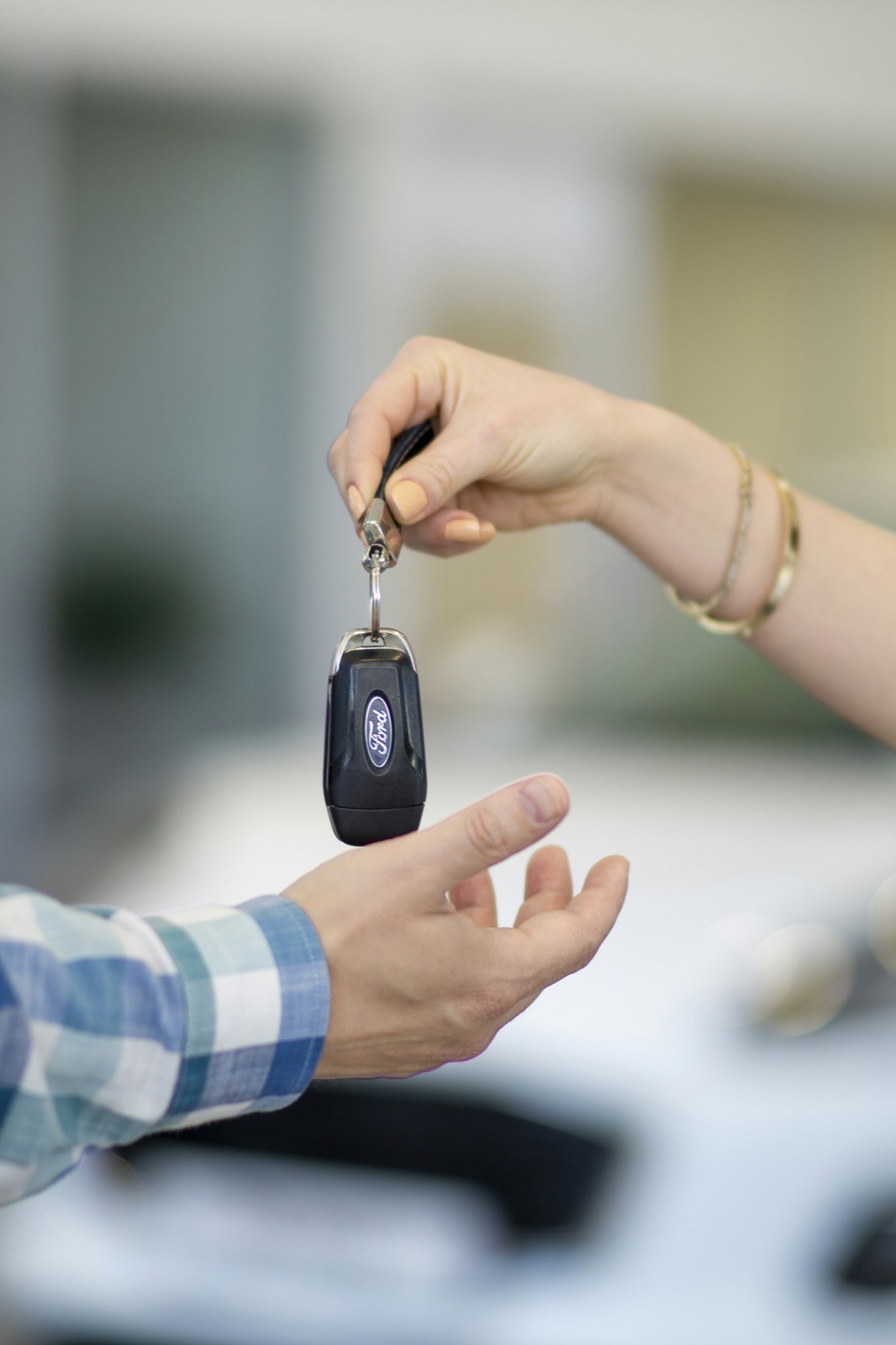 Car keys being handed to a new owner